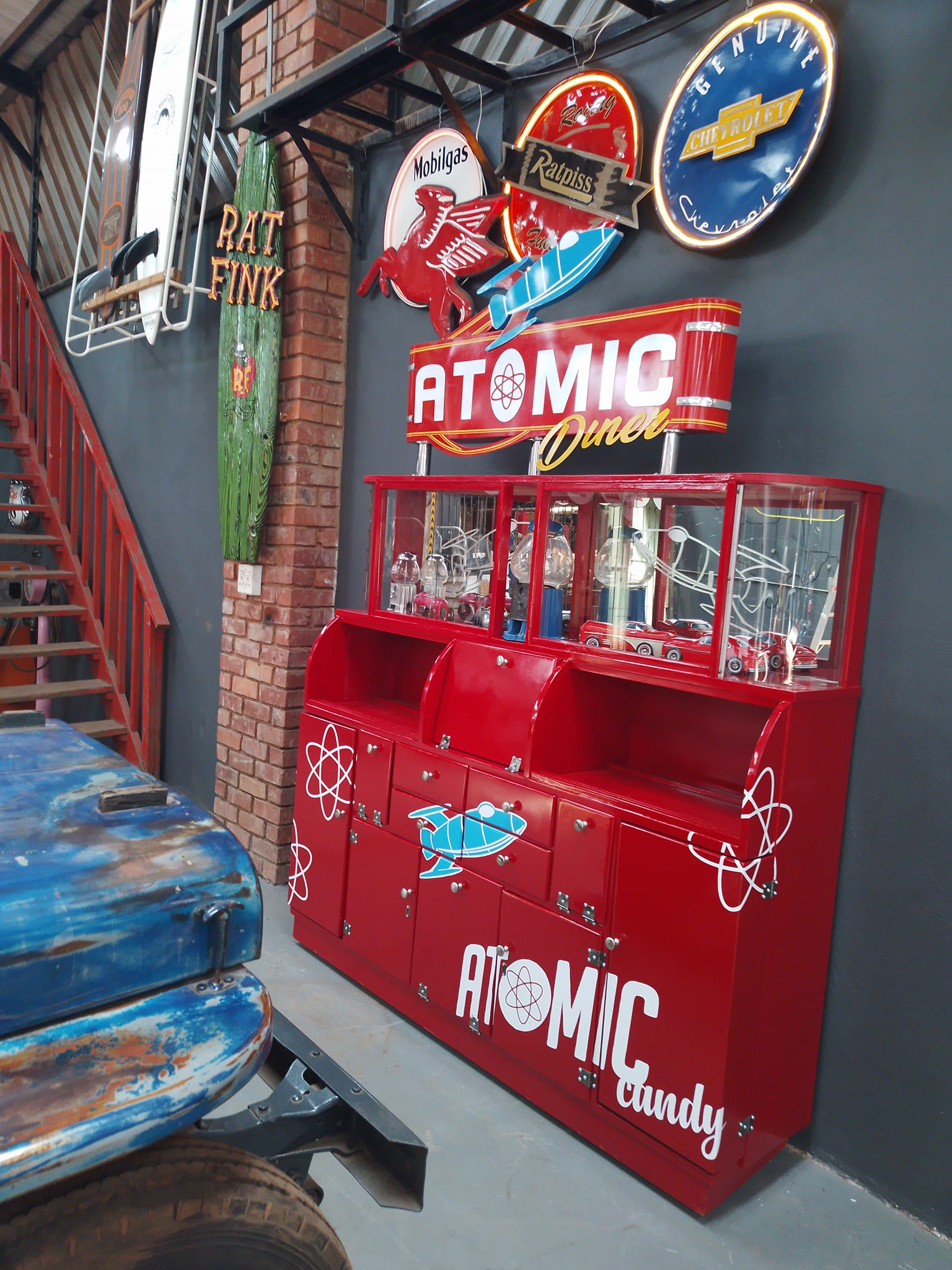 Red atomic diner display cabinet with wall signs