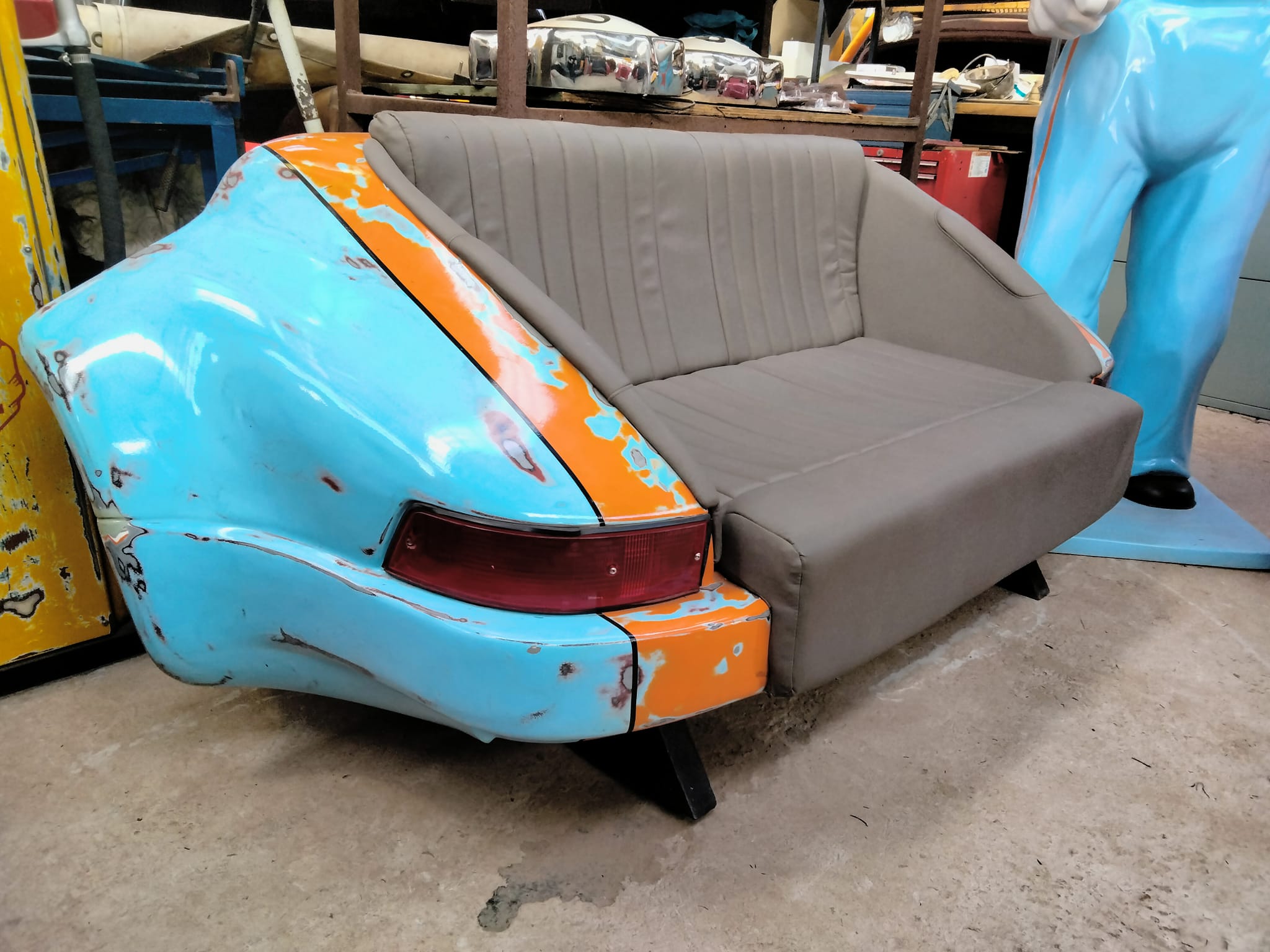Blue and orange car rear converted into a couch