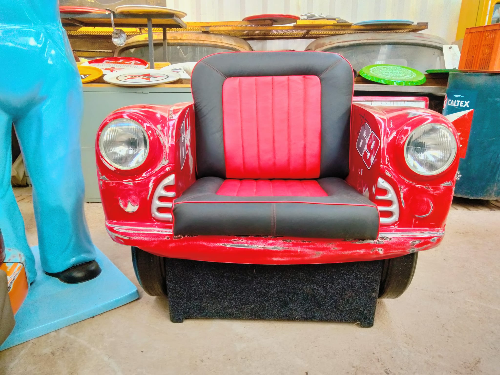 Red fiberglass car couch with black and red upholstery