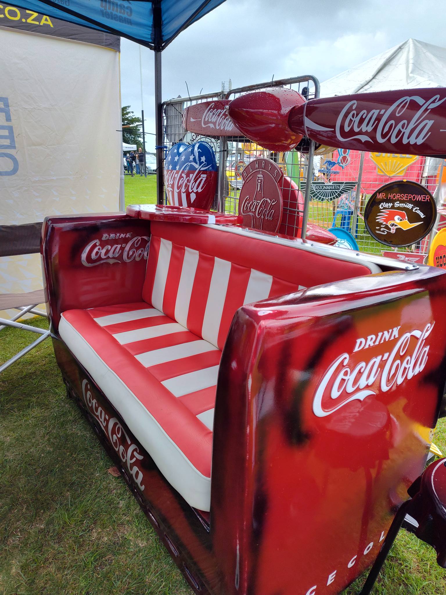 Custom red and white fiberglass couch at an outdoor display