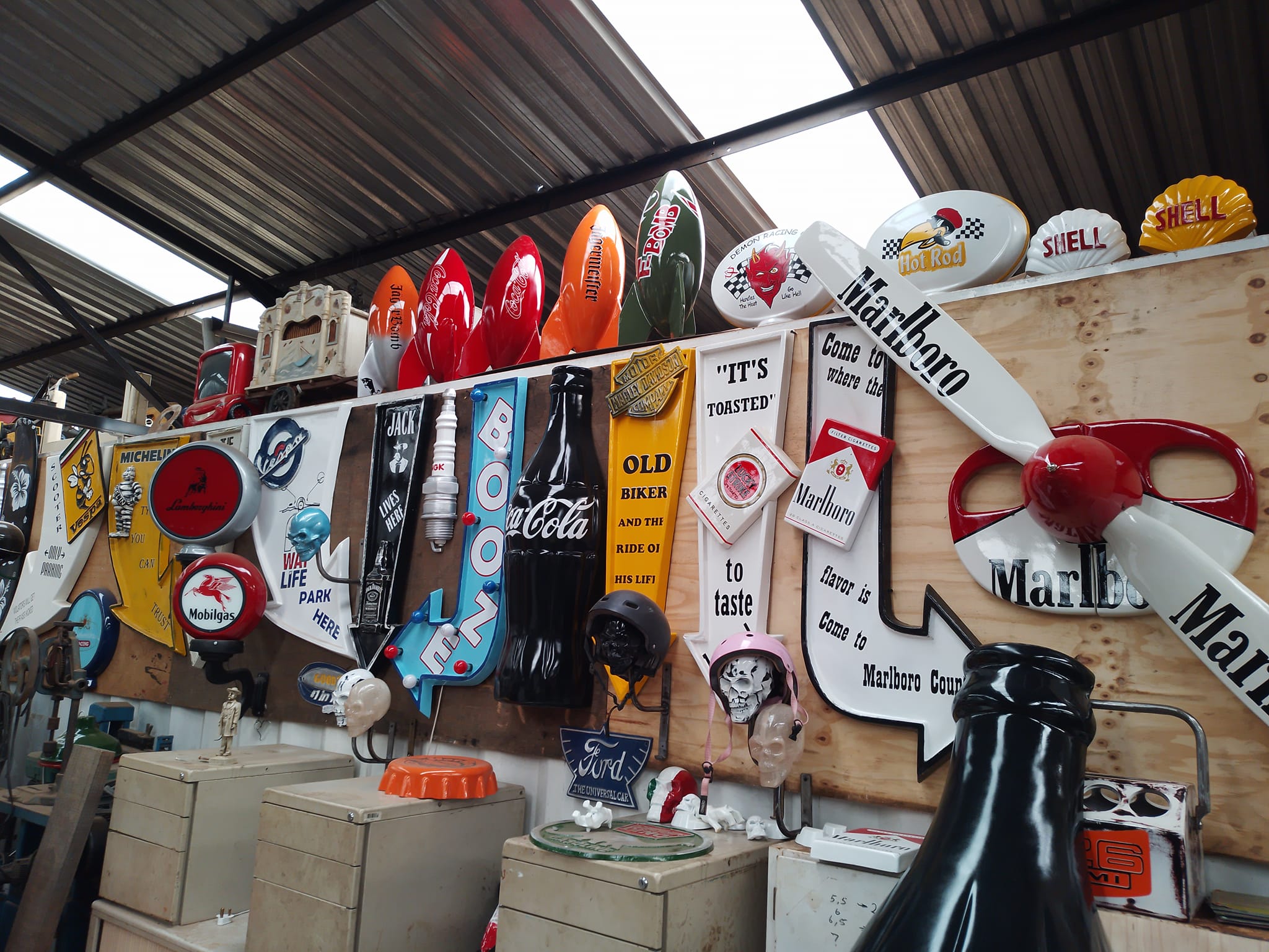 Workshop wall covered with custom fiberglass signs and panels
